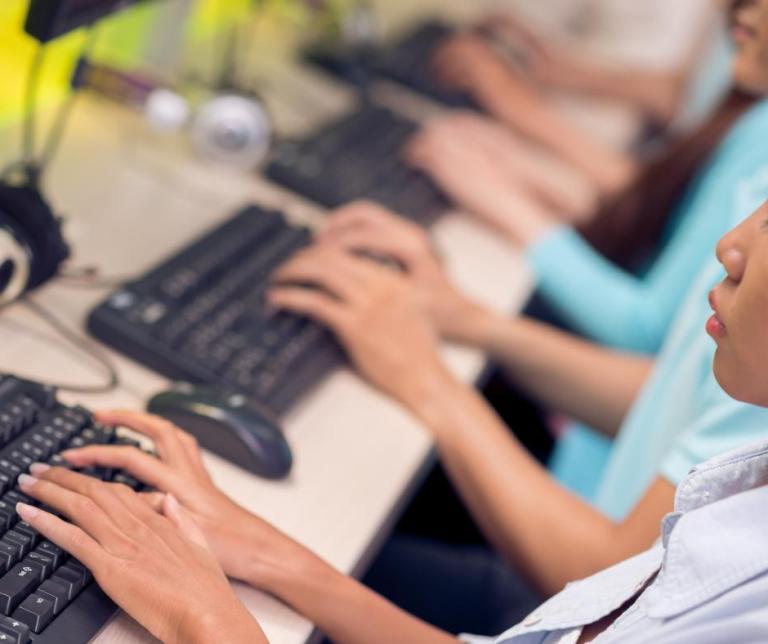 Students typing on keyboards.